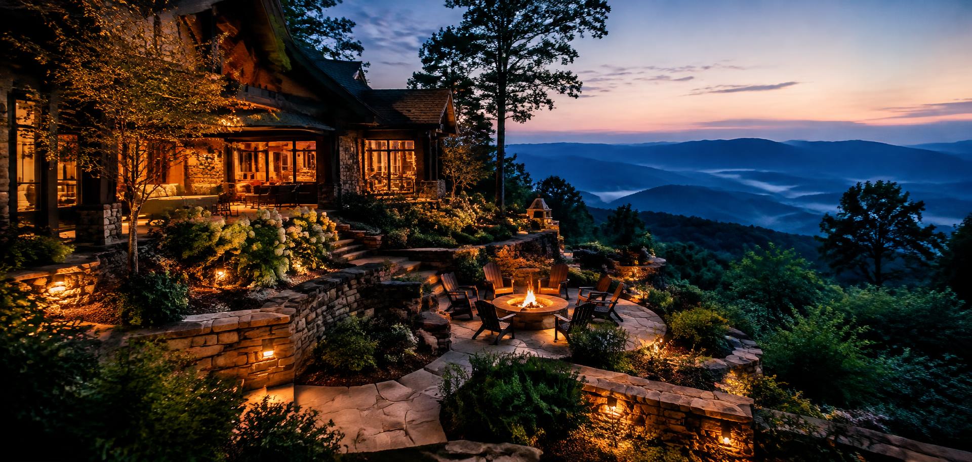 Lit stone terraces and fire pit overlooking mountain ridges at twilight (illustrative image)